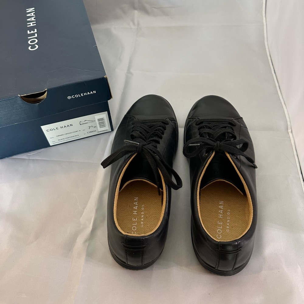 Cole Haan men’s sneakers black leather. Men’s size 7 1/2 and women’s size 9.